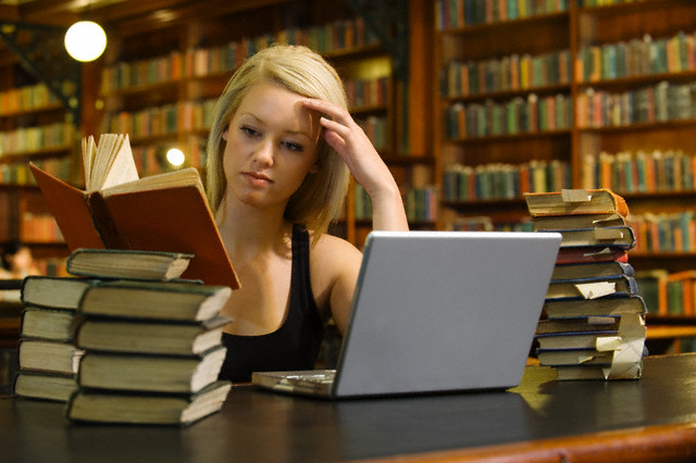 College Student Studying in Library