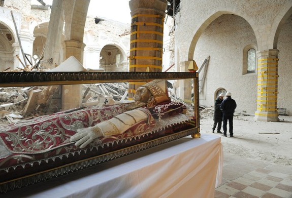 The body of Celestino V is seen at the Collemaggio Basilic after Pope Benedict XVI put on the urn (a shrine of crystal) a white stole reminiscent of his visit in L'Aquila on April 28, 2009 in L'Aquila. Pope Benedict XVI Tuesday visited Onna, the village worst hit by the earthquake three weeks ago in central Italy, calling for the devastated region to be 